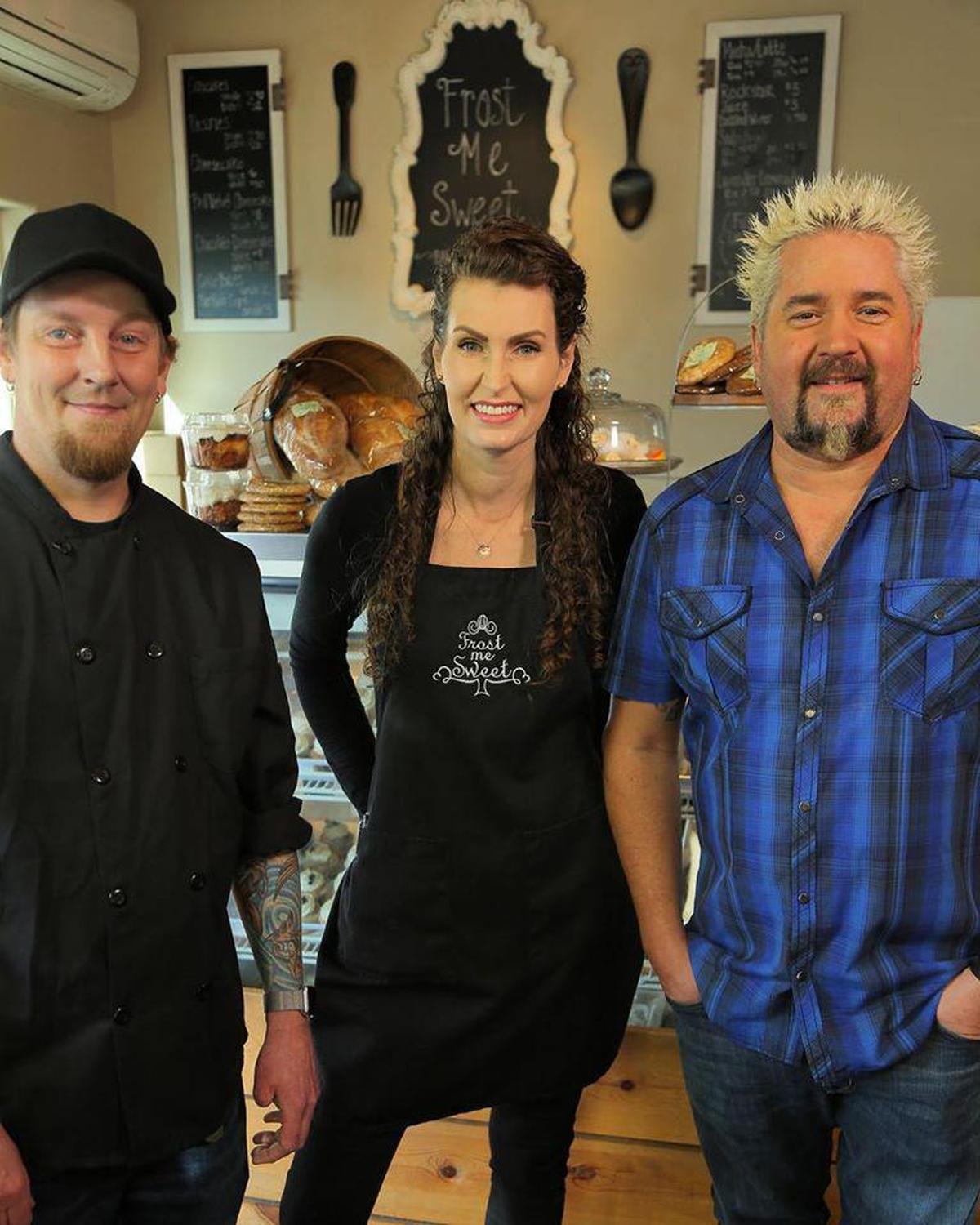 Jason and Megan Savely stand with Guy Fieri during a taping of an episode of Diners, Drive-Ins and Dives for the Food Network.