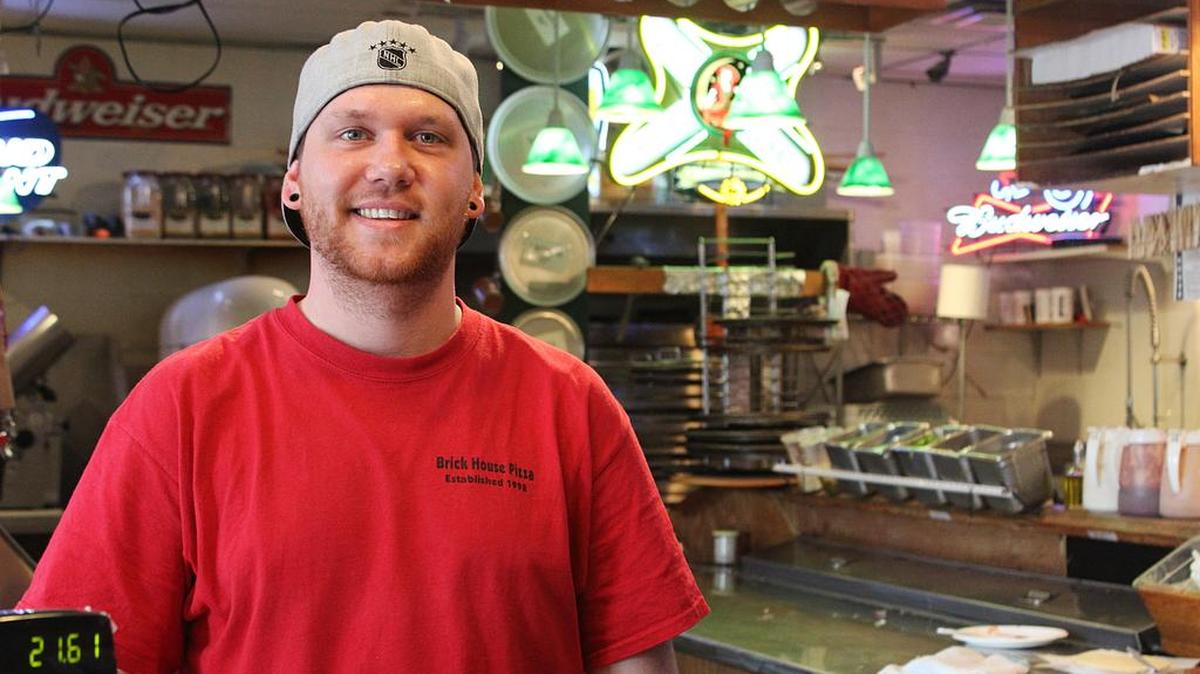Sam Debrine, manager of Brick House Pizza, stands behind the counter of the popular West Richland restaurant.