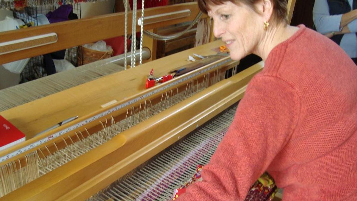 Susan Schmieman weaves a fabric strip rug on her countermarche loom.