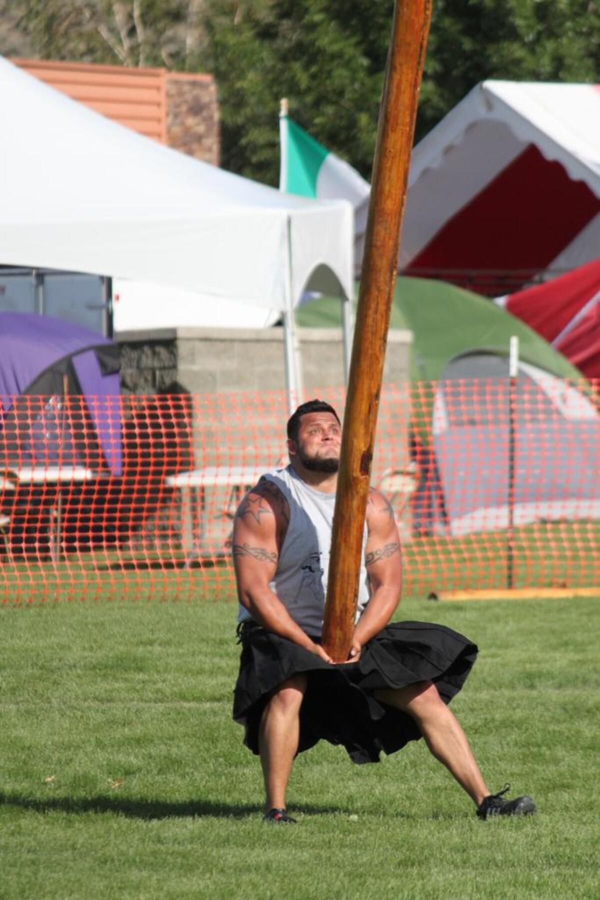 Athletes compete in the Highland Games at a past Scottish Fest.