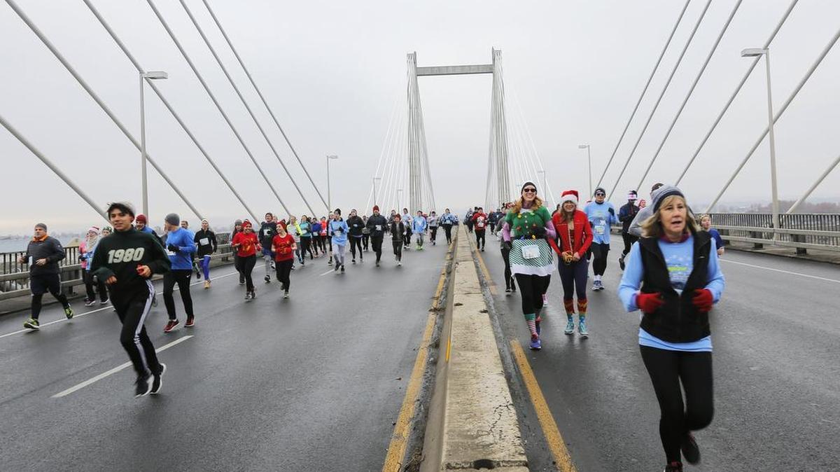 Local runners run across the Cable Bridge last year during the 39th annual Lampson Cable Bridge Run.