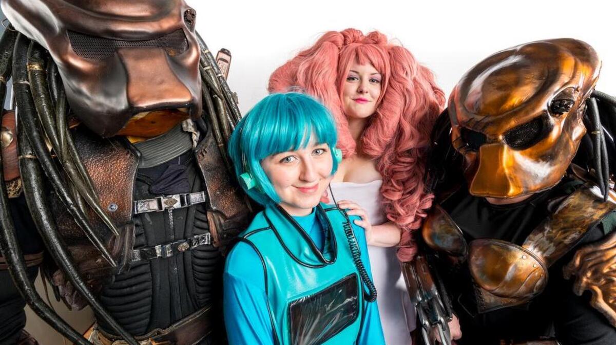 Participants in the 2017 RadCon science fiction/fantasy convention preview their costumes. From left to right: Jess Langdell of Los Angeles, Calif., in his Predator costume; Tana Savage of Richland in her BMO costume from the animated series “Adventure Time;” Suzette Gurtisen of Richland in her Rose Quartz costume from the animated series “Steven Universe;” and Bridgit Corbin-Langdell of Richland in her female Predator costume.