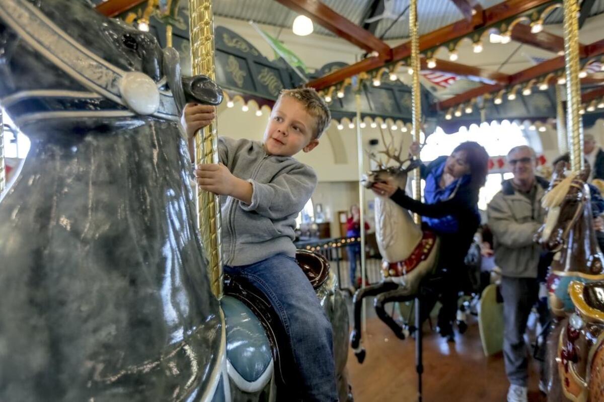 Kasen Arendell, 3, recently rides on a horse on The Gesa Carousel of Dreams in Kennewick after the unveiling of a new carved reindeer named Spirit. Arendell of Kennewick was accompanied by his grandparents Greg and Janice Pocek.