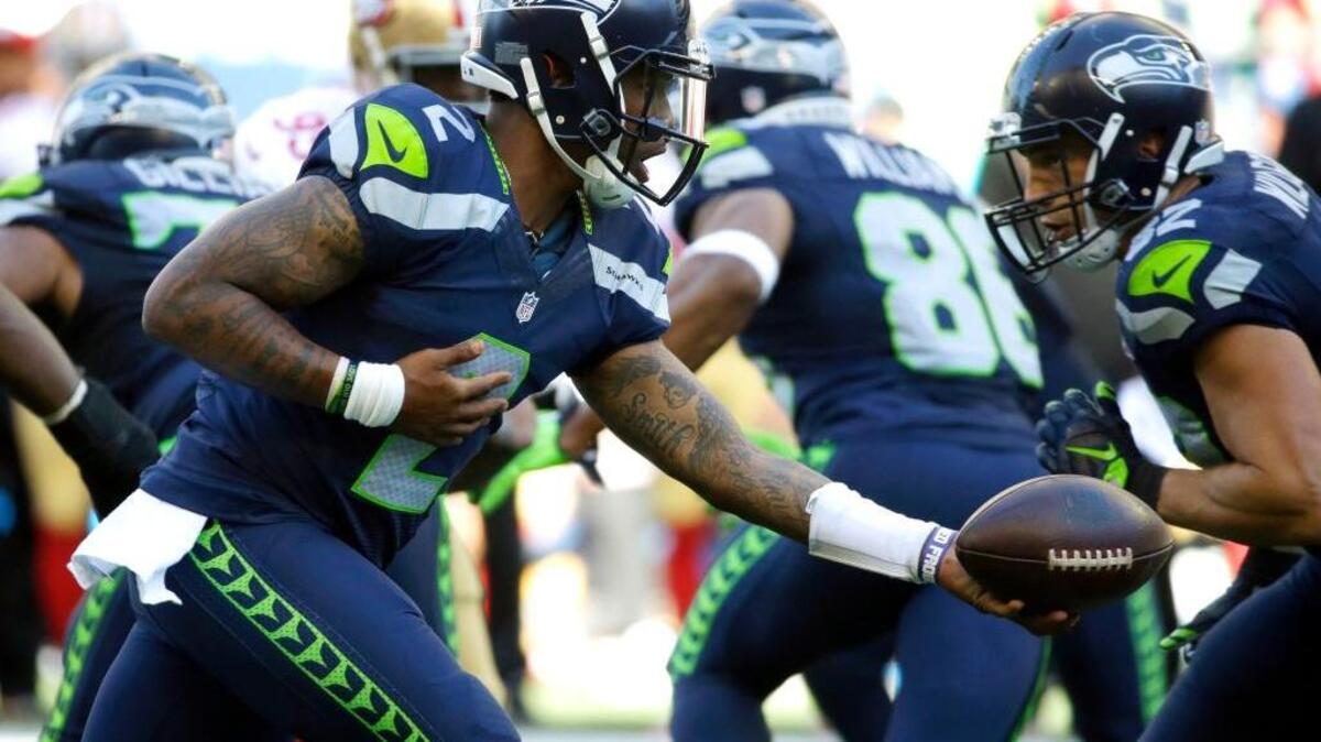 Seattle Seahawks quarterback Trevone Boykin (2) hands off the ball during the second half of an NFL football game against the San Francisco 49ers on Sunday, Sept. 25 in Seattle.