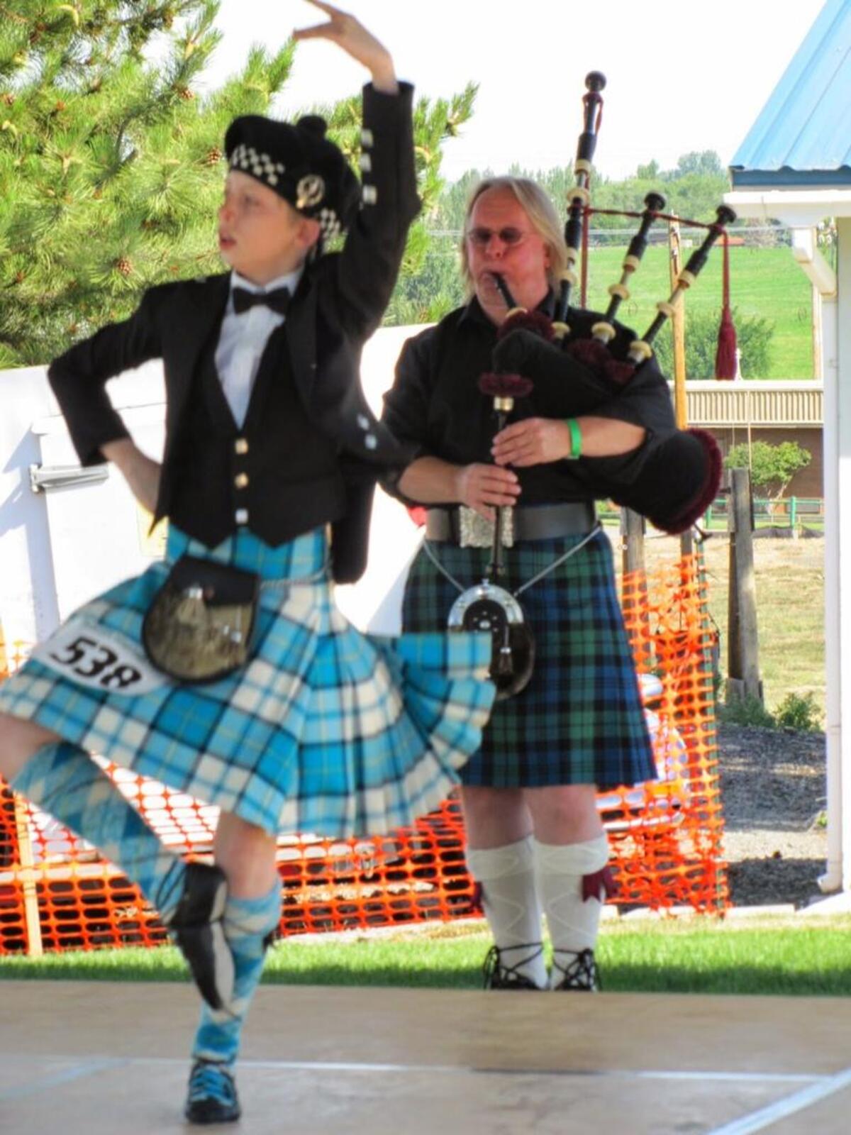 A highland dancer and piper perform at a past Scottish Fest and Highland Games.