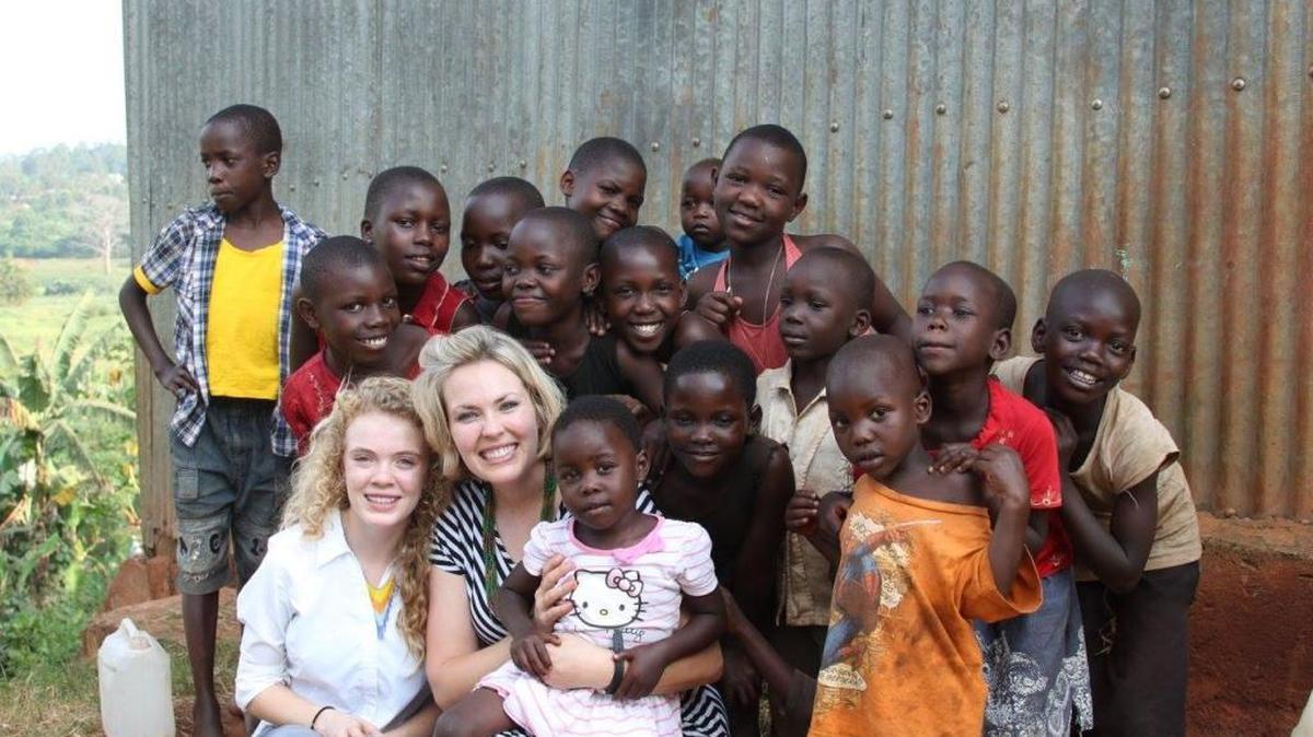 Natalie Teeples, center, is organizing a benefit concert June 10 in Richland to raise money to build an education center for children with disabilities in Lugazi, Uganda. She pictured with her daughter, McKinzi, and several children from Lugazi.