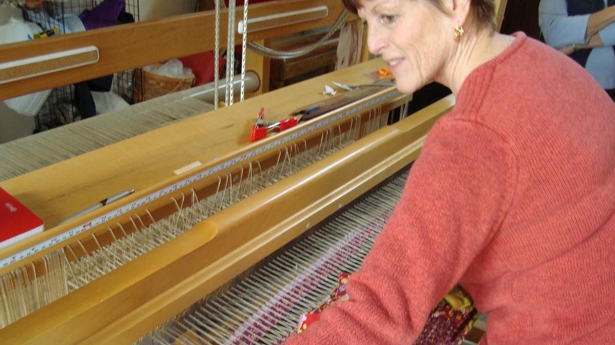 Susan Schmieman weaves a fabric strip rug on her countermarche loom.