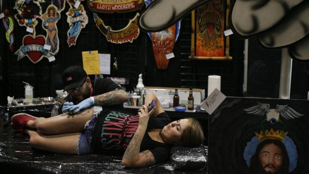 Tattoo artist Lloyd Woodrome works on a tattoo for Emilie Hallman of Richland at the 2013 Three Rivers Tattoo Convention in this file photo. This year’s convention is Sept. 26-28 at the Three Rivers Convention Center in Kennewick.