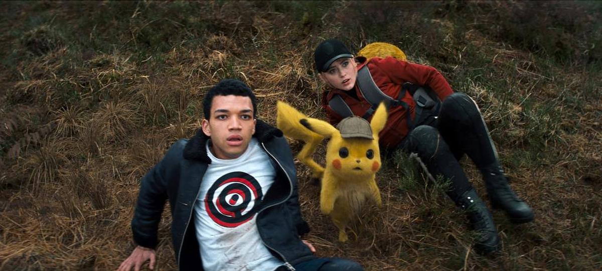 This image released by Warner Bros. Pictures shows Justice Smith, left, the character Detective Pikachu, voiced by Ryan Reynolds, and Kathryn Newton in a scene from "Pokemon Detective Pikachu."