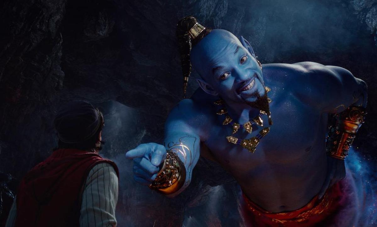 This image released by Disney shows Mena Massoud as Aladdin, left, and Will Smith as Genie in Disney's live-action adaptation of the 1992 animated classic "Aladdin."
