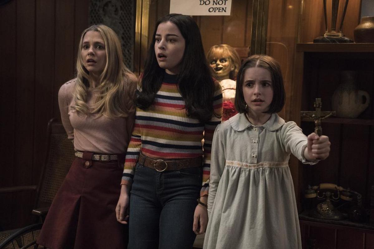 This image released by Warner Bros. Pictures shows Madison Iseman, from left, Katie Sarife and McKenna Grace in a scene from the horror film, "Annabelle Comes Home."