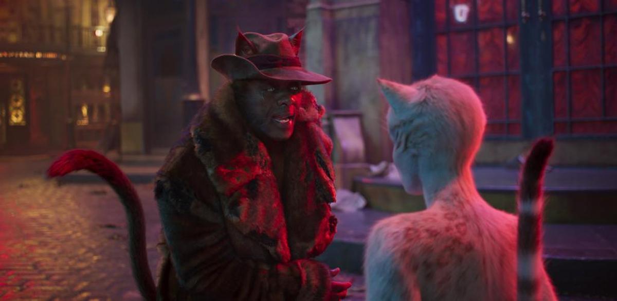 Idris Elba as Macavity, left, and Francesca Hayward as Victoria in a scene from “Cats.”