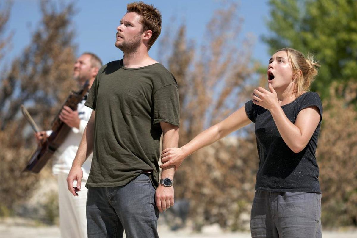 This image released by A24 shows Jack Reynor and Florence Pugh, right, in a scene from the horror film "Midsommar."