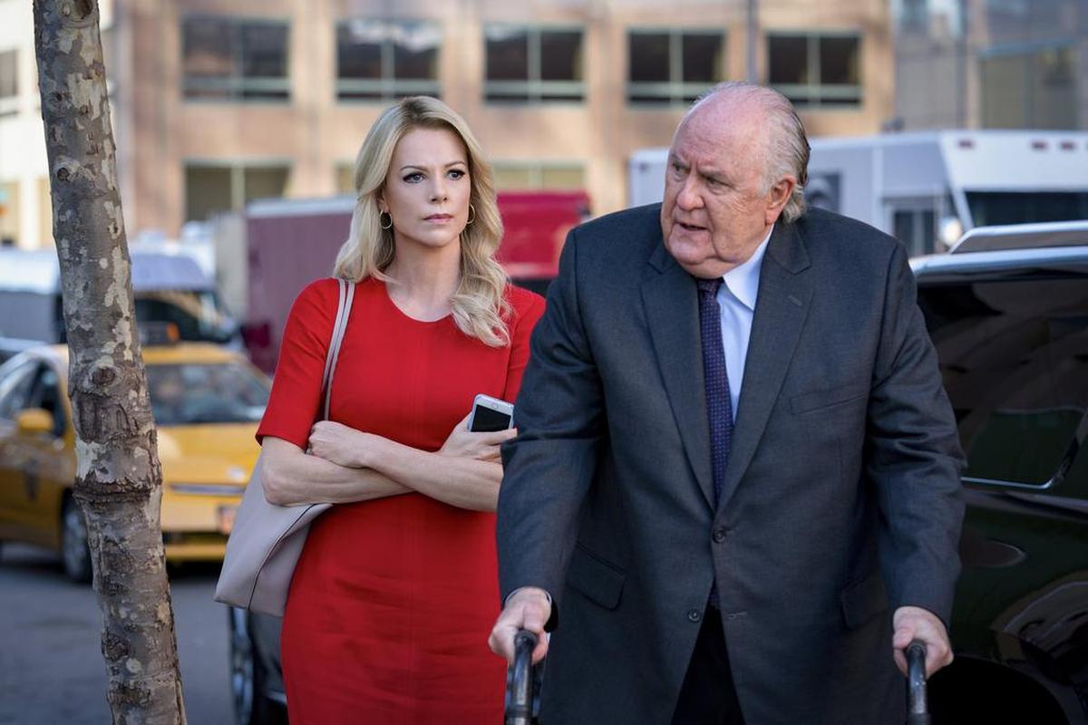 Charlize Theron, left, and John Lithgow in a scene from “Bombshell.”