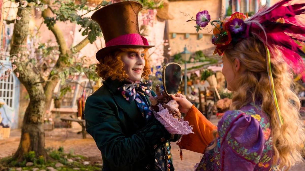 Johnny Depp, left, and Mia Wasikowska appear in a scene from “Alice Through the Looking Glass.”
