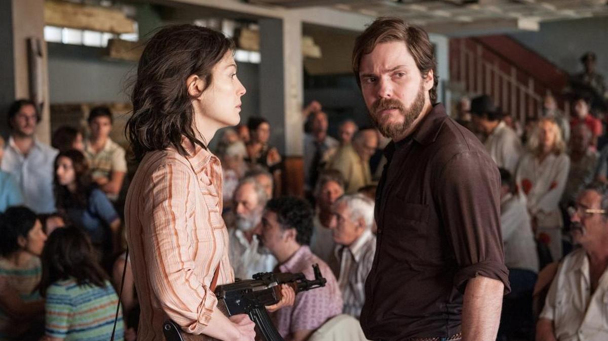 Rosamund Pike as Brigitte Kuhlman and Daniel Brühl as Wilfred Böse in “7 Days in Entebbe.”