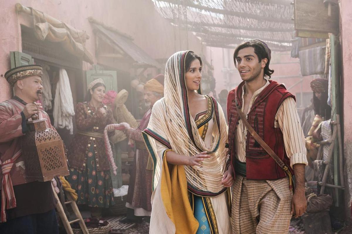 This image released by Disney shows Naomi Scott as Jasmine and Mena Massoud as Aladdin, right, in Disney's live-action adaptation of the 1992 animated classic "Aladdin."