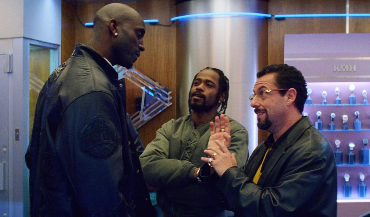 This image released by A24 shows Kevin Garnett, Lakeith Stanfield and Adam Sandler in a scene from “Uncut Gems.”