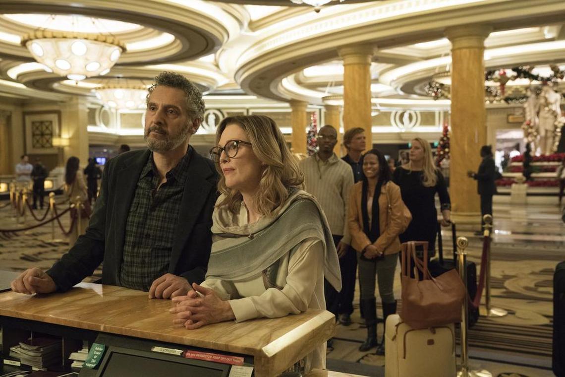 This image released by A24 shows John Torturro and Julianne Moore in a scene from "Gloria Bell." Everyone is vanishing around Julianne Moore's title character in Sebastian Lelio's "Gloria Bell." The disappearances don't come with blood-curdling shrieks or thundering score cues, but with the humdrum ebb of middle age. People just move away or recede from view.