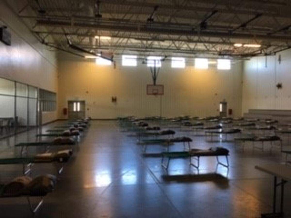 Temporary housing in gym during COVID