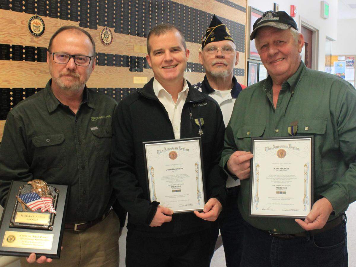 The crew of Tidewater Transportation’s tug Ryan Point was honored for saving the lives of two boaters in September. From left are Port Captain Brian Fletcher, Captain Josh Burrows, Commander Robert Gates of Legion Post 57 and deck mechanic Ken Marvel.