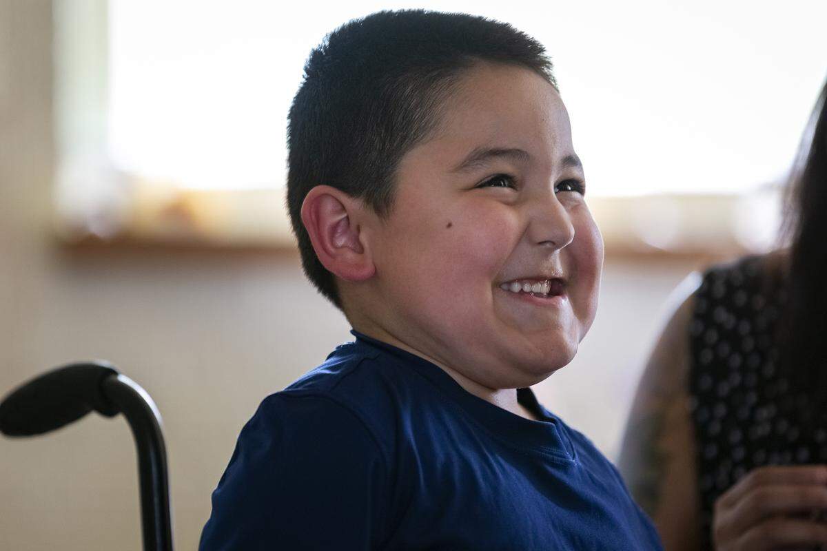 Harper Ramos grins as he speaks about basketball with his mother, Crystal Ramos.