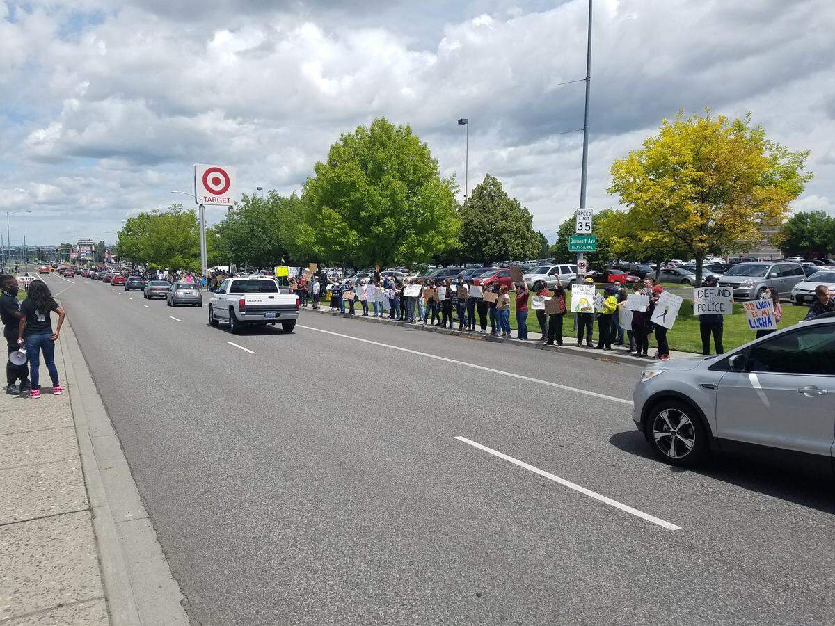At least 1,000 Black Lives Matter protesters lined Columbia Center Boulevard near Target on Saturday, waving signs at passing cars and chanting.