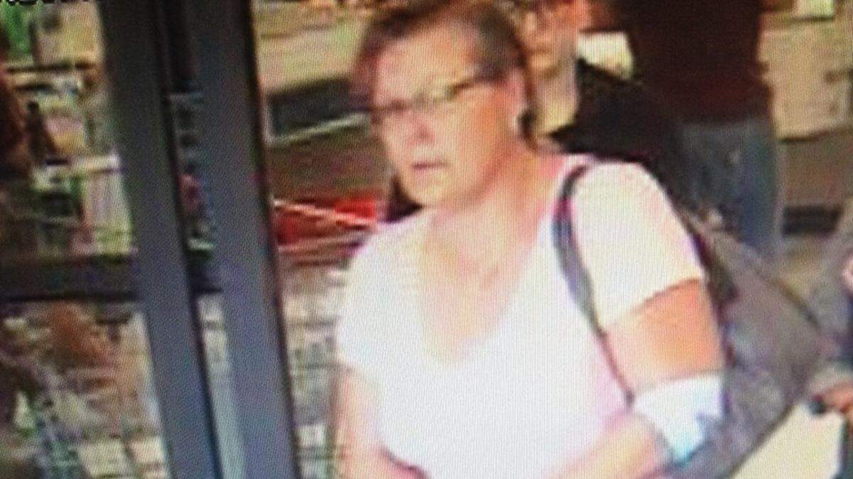 Kennewick police are searching for this woman after she allegedly tried to use her cellphone in a grocery store restroom to spy on another customer.