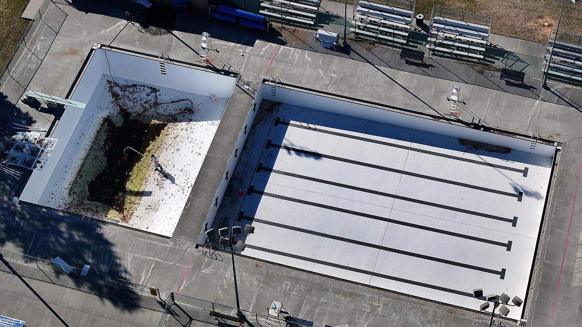 A worker cleans out windblown debris from the deep portion of the Kenneth E. Serier swimming pool in downtown Kennewick. Taken Feb. 26, 2025.
