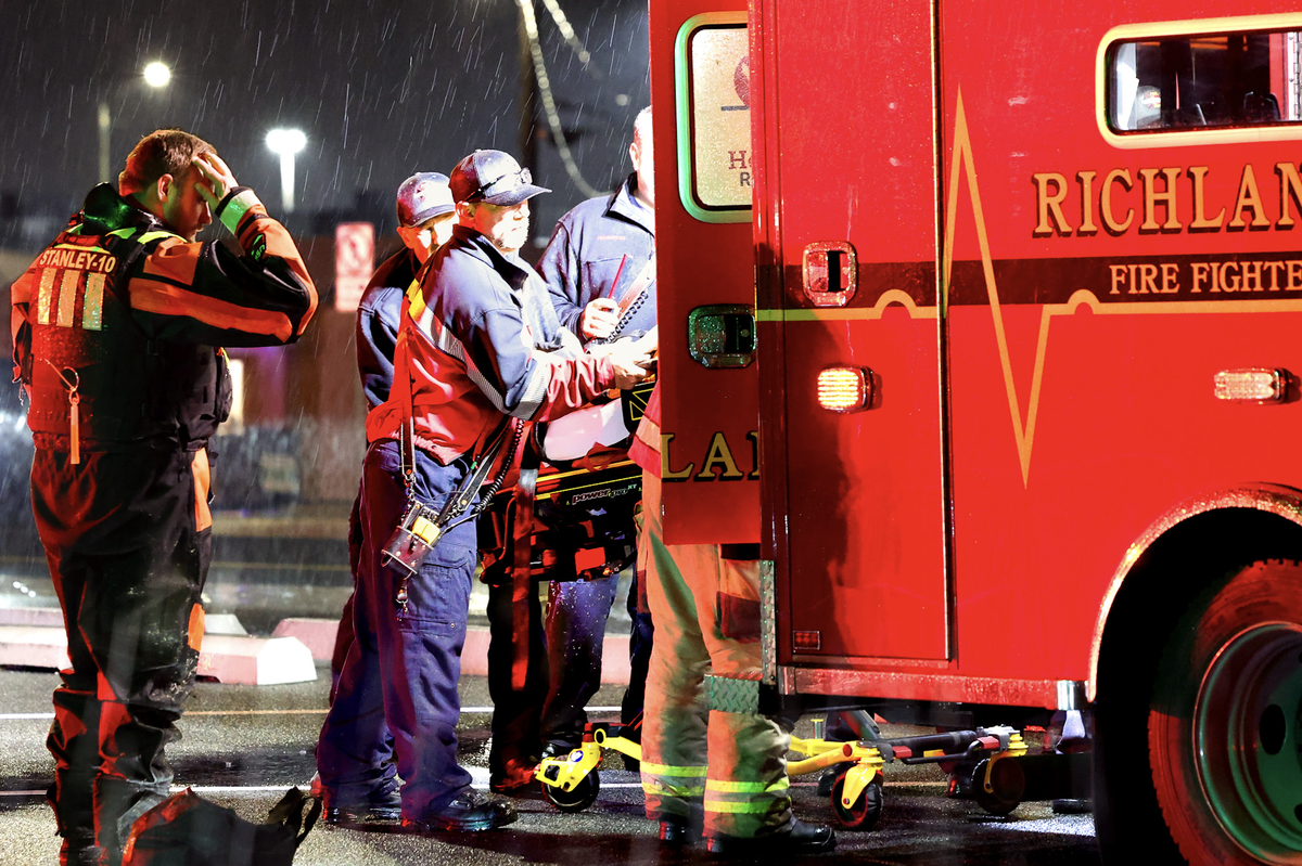 Richland first responders and divers load a man they rescued Thursday from Bateman Island.