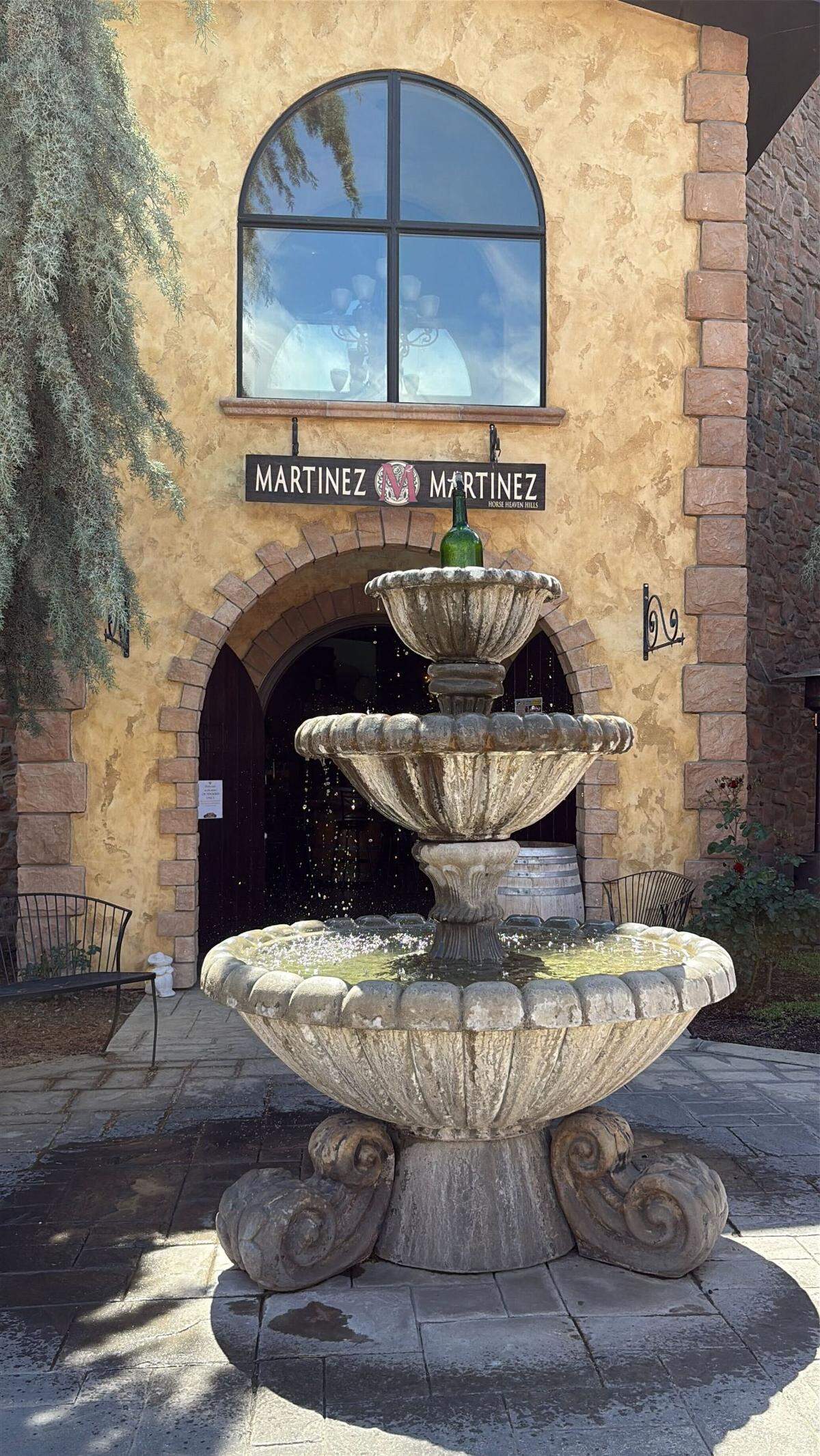 The Winemakers Loft building hosts three wineries in Vintners Village. In the center, behind this fountain featuring a wine bottle topper, is Martinez and Martinez Winery.