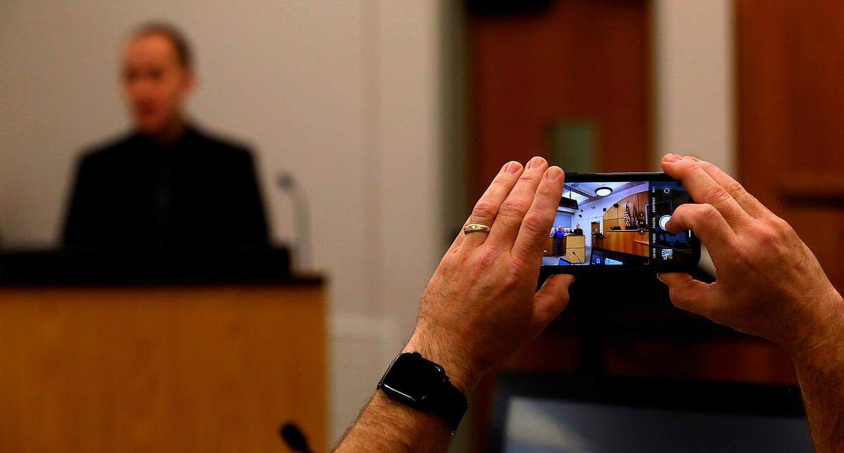 A cellphone camera captures January Wells during his graduation speech at the Benton County Veterans Therapeutic Court at the Benton County Justice Center in Kennewick.