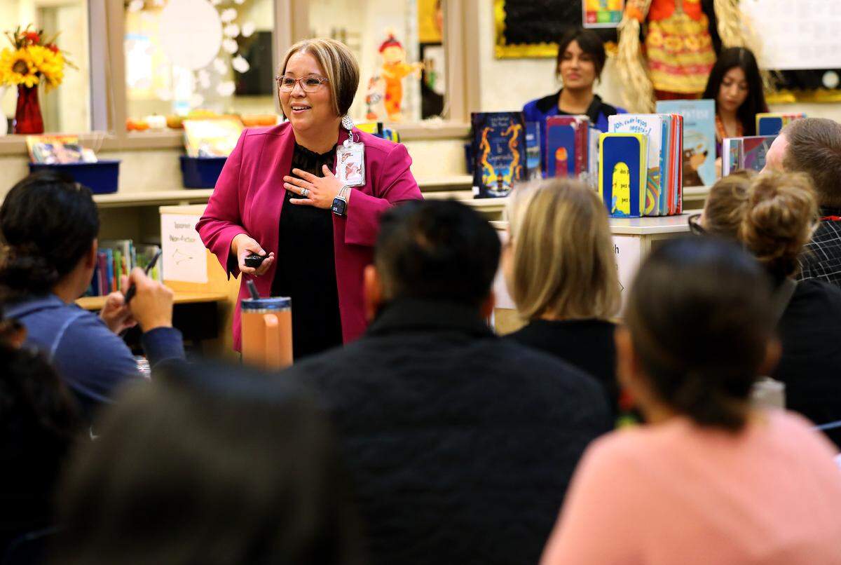 Principal Maria Sandoval speaks with visting educators during a Dual Language Showcase event at Virgie Robinson Elementary School at 125 S. Wehe Ave. in Pasco.