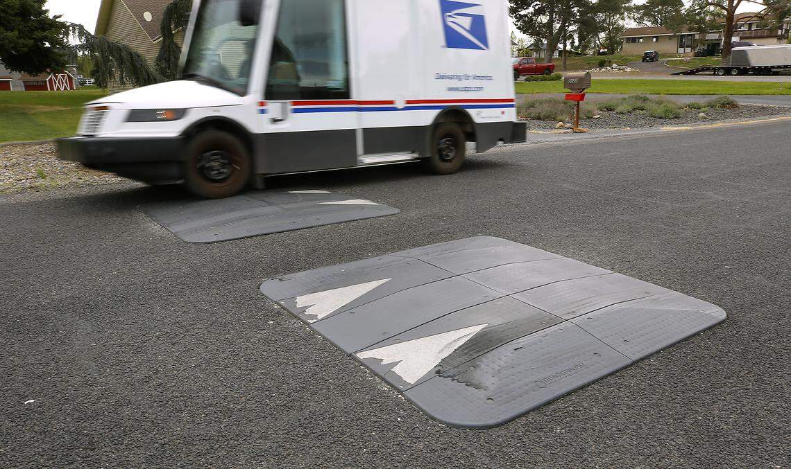 A USPS delivery truck drives over a set of speed humps installed on North Road 96 between West Argent Road and Balfour Court in west Pasco.