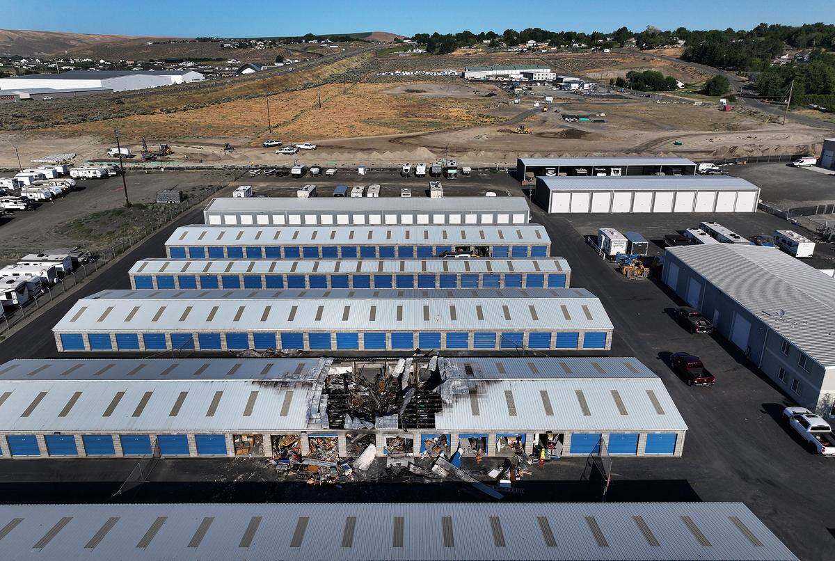 Fourteen storage units at Badger Mountain Storage were heavily damaged, one man severely burned and a second person hurt when fire erupted at the site off Reata Road on July 4.