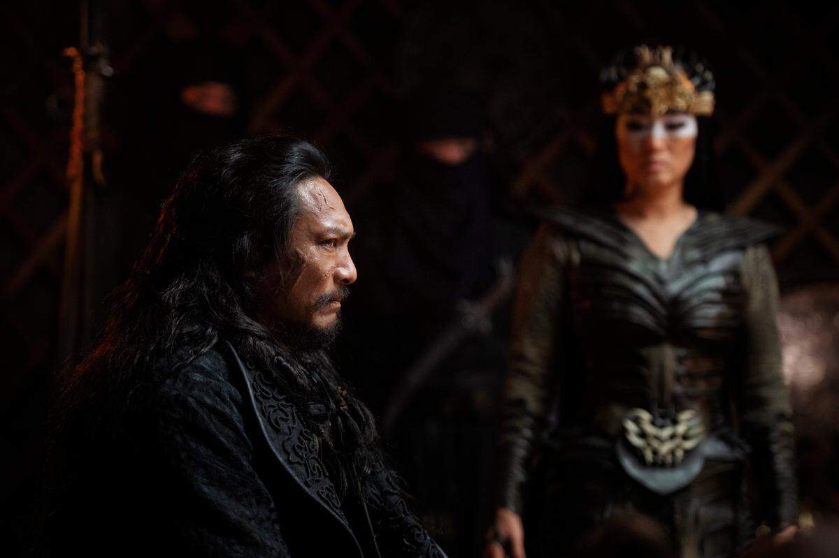 This image released by Disney shows Jason Scott Lee, left, and Gong Li in a scene from “Mulan.”