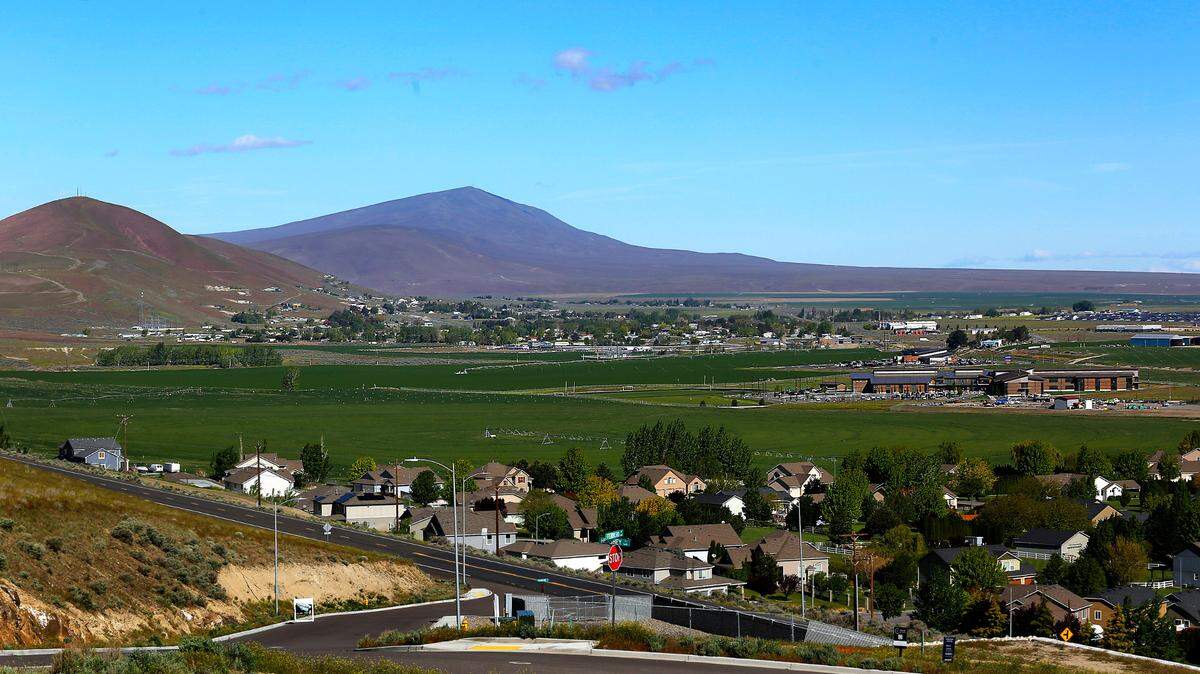 View from Candy Mountain in West Richland shows land for future Richland School District high school adjacent to Leona Libby Middle School, at right, and the district administration building off Keene Road. Rattlesnake and Red Mountains are in the background.
