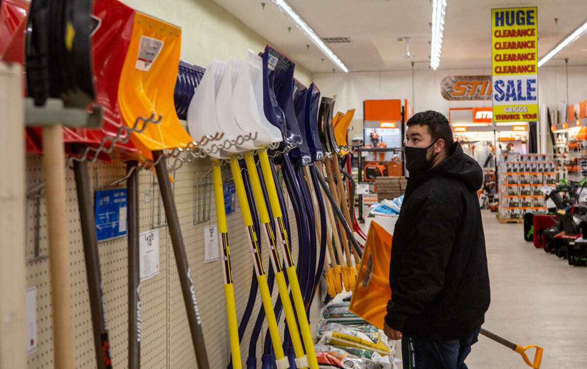 Efrain Davila, of Pasco, looks for a shovel to clear out his driveway at Grigg’s Department Store in Pasco.