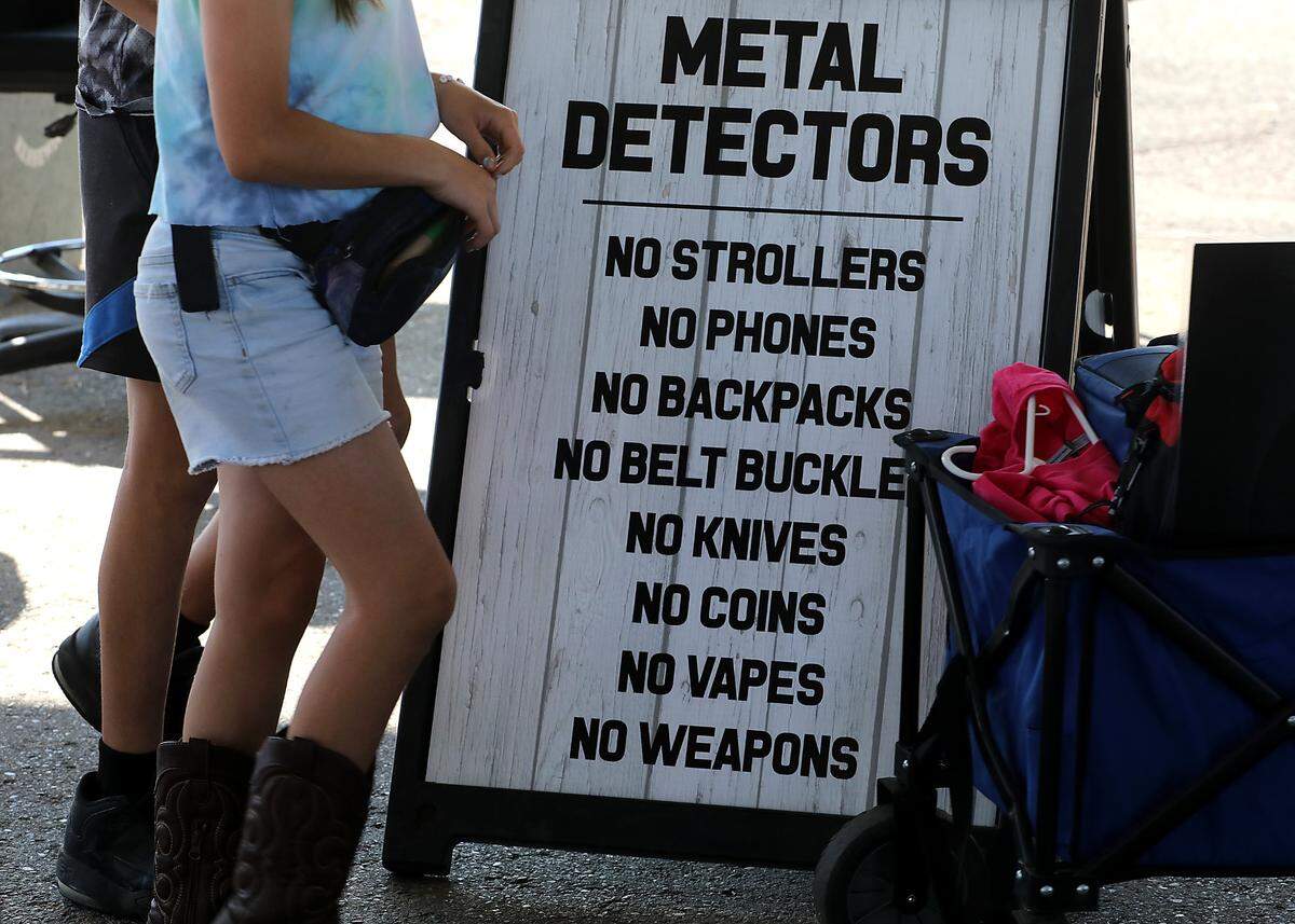 Fairgoers aarriving at the Benton Franklin Fair and Rodeo in Kennewick with must first pass through security stations with metal detectors and bag searches before being allowed into the fairgrounds. A sign near the entrance list some of the items not allowed.