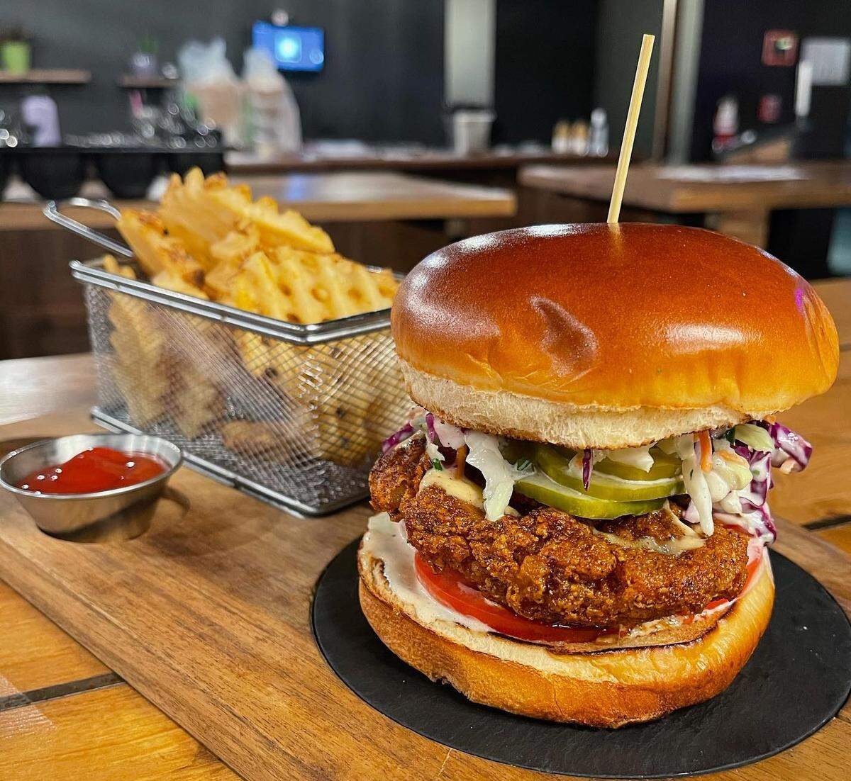 Proof Kitchen and Bar in Pasco has created a Nashville Hot Chicken Sandwich with crispy chicken thigh, Nashville hot sauce, white BBQ sauce, cabbage and carrot Slaw, pickles and served on a brioche bun.