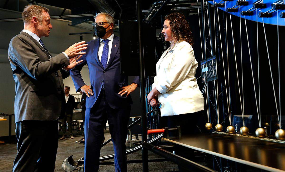 Michael Landry, left, head of LIGO Hanford observatory, answers questions from Gov. Jay Inslee during a tour of the new LIGO Exploration Center. Amber Strunk, LIGO outreach lead, at right, stand near a pendulum snake exhibit in the new 5,000-square-foot center which was funded by a $8.1 million grant from Washington state.