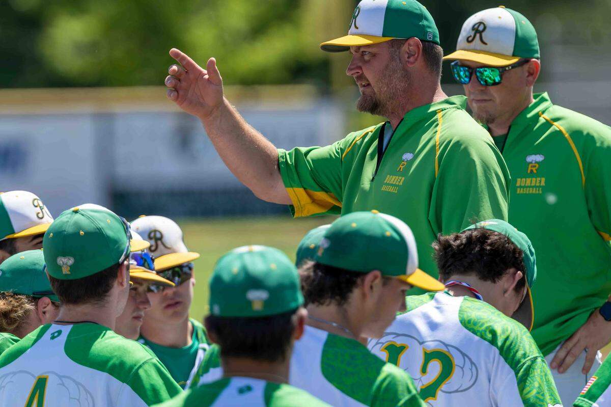 Richland Bombers head coach Grant Richardson speaks with his team following the Bombers’ opening round victory over Skyline during the WIAA 4A State Baseball Championships Saturday at Bomber Bowl in Richland.