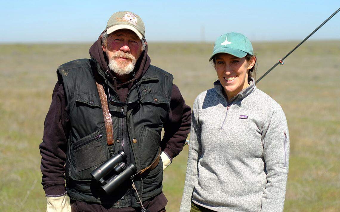 Denver Holt, Owl Research Institute founder, stands next to Lindsay Chiono, Confederated Tribes of the Umatilla Indian Reservation Program habitat ecologist-biologist, after helping install a livestreaming camera near a burrowing owl nest at the former Umatilla Army Depot near Hermiston.