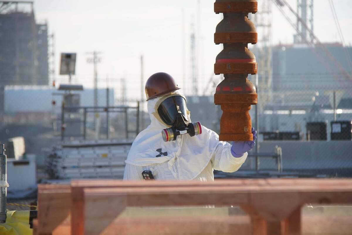 A pump is lowered into an underground tank holding radioactive waste at the Hanford nuclear site in Eastern Washington