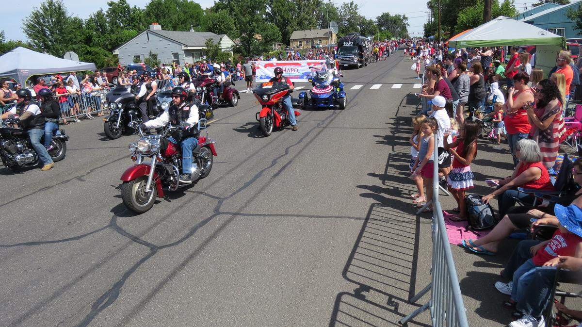 The local branch of the American Legion Riders passes during Wednesday's Grand Old 4th Parade in Pasco. Thousands lined the streets in the morning to watch the annual parade, which featured bands, dance groups, horses and floats as it wound through east Pasco and ended at the Pasco School District administration building.