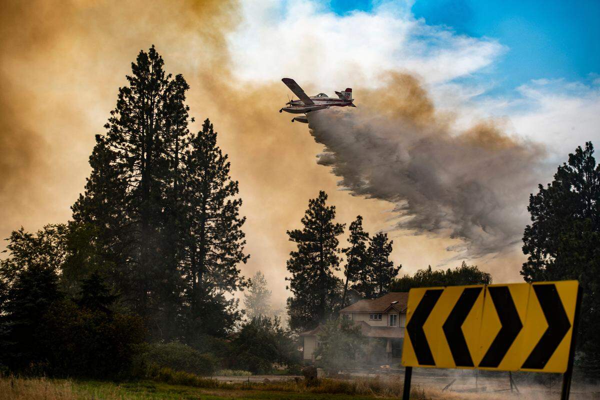 An airplane hits the Silver Lake fire near Cheney, Wash., earlier this month. Washington wildfires are adding to the smoke choking the Tri-Cities.