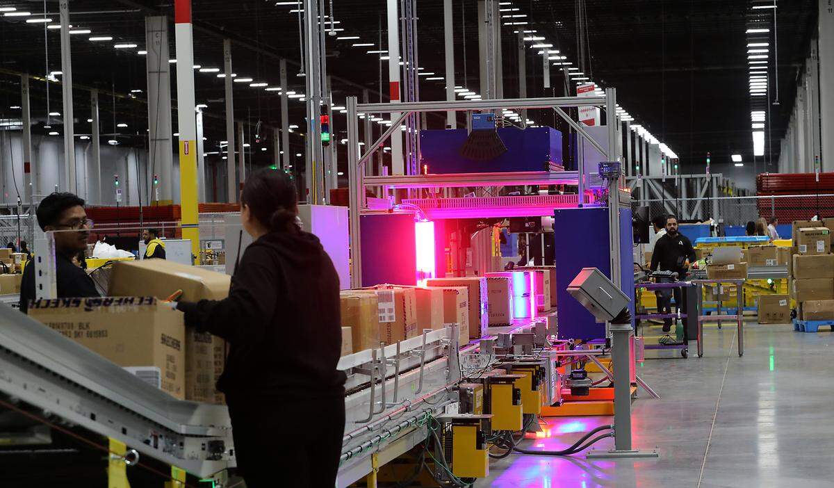 Incoming boxes are optically scanned and labeled at an Amazon package hub at 1351 S. Road 40 East in Pasco.
