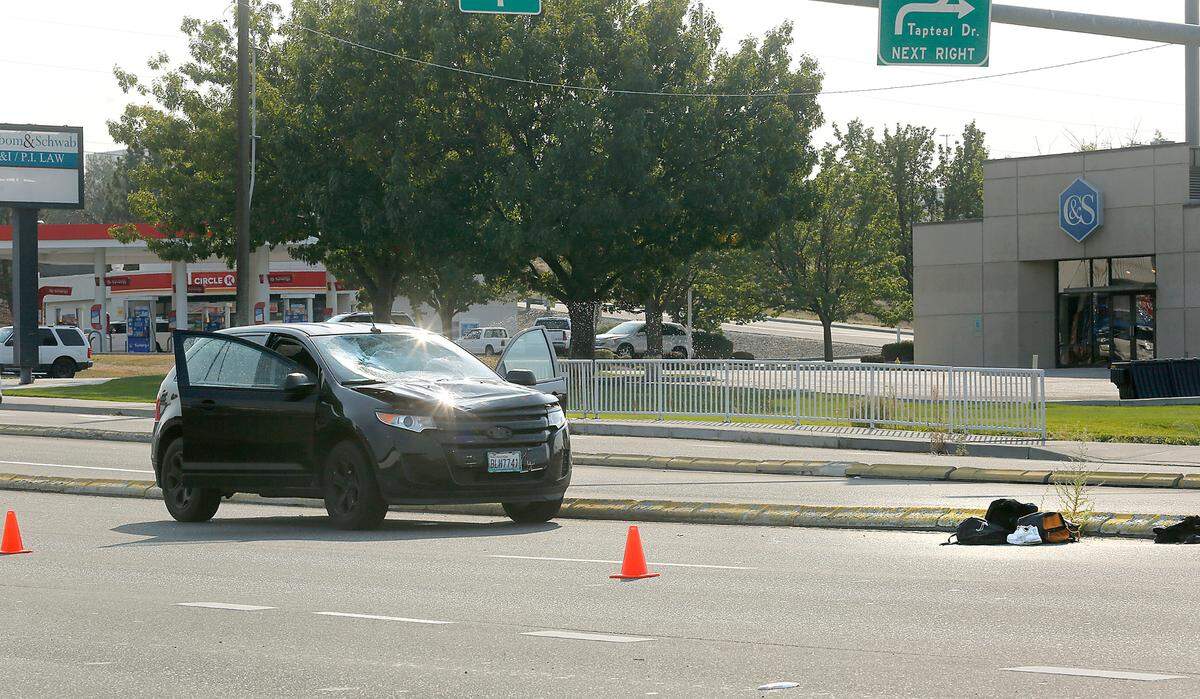The hood is bent and windshield smashed on the Ford Edge involved in Friday’s collision with a pedestrian on Columbia Center Boulevard near the Highway 240 interchange. Police say they driver is cooperating and witnesses reported she appeared be driving legally.