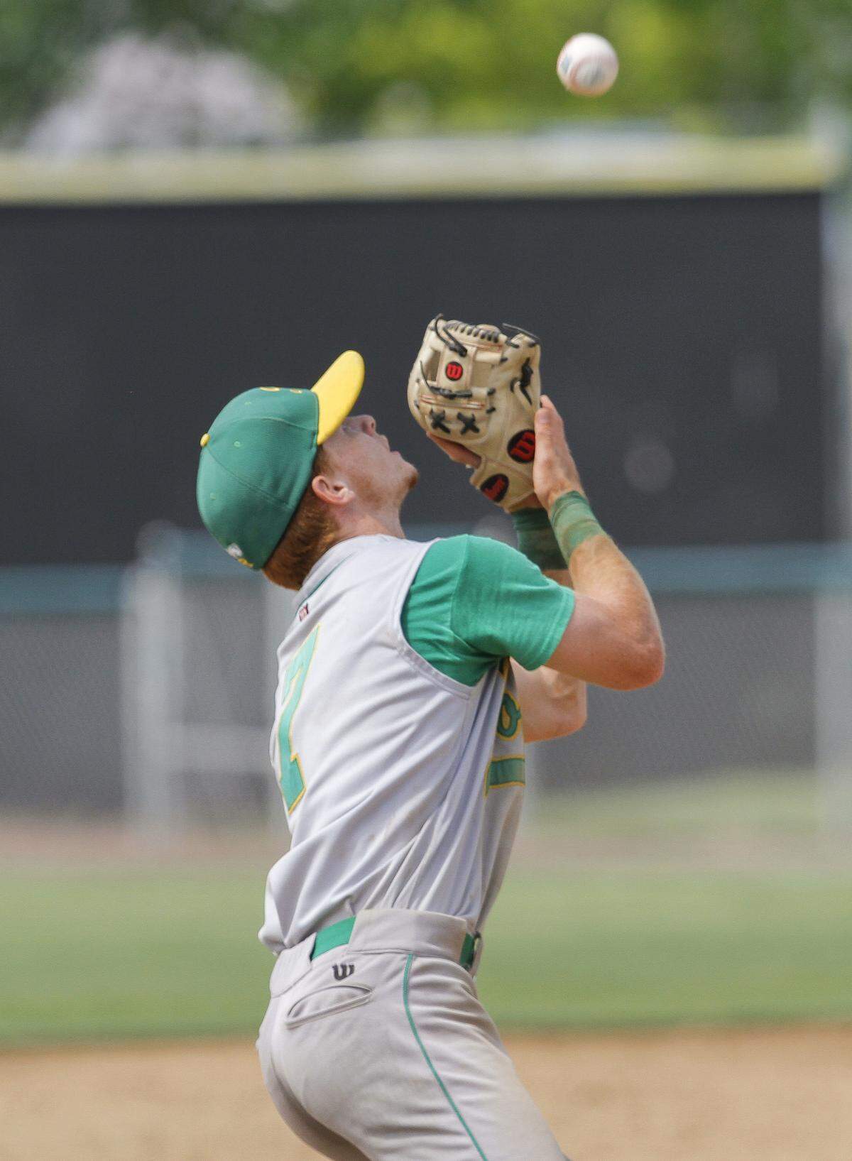 Richland shortstop Adam Weissenfels catches a flyball during a 4A state semifinal against Federal Way on Friday at Gesa Stadium.  The Bombers won 11-0.