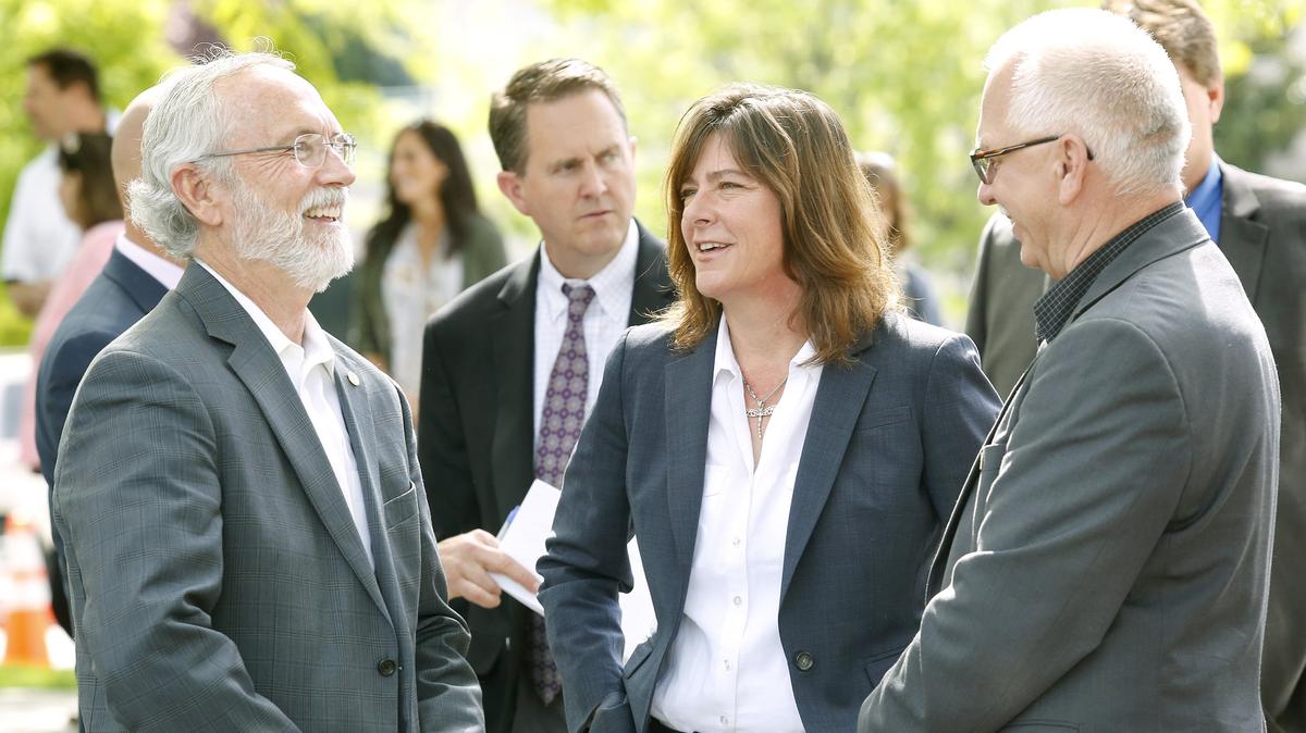 Rep. Dan Newhouse, R-Wash., Anne White, DOE assistant secretary for environmental management, and Doug Shoop, DOE Richland operations manager, from left, share a light moment before the start of Thursday's dedication ceremony for the new Hanford Workforce Engagement Center in Richland. The facility is designed to help all current and former Hanford workers and their families who have occupational health questions. Watch a video at: tricityherald.com/video